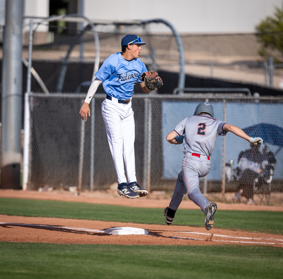 Matthew Bauer leaping for a throw at first base