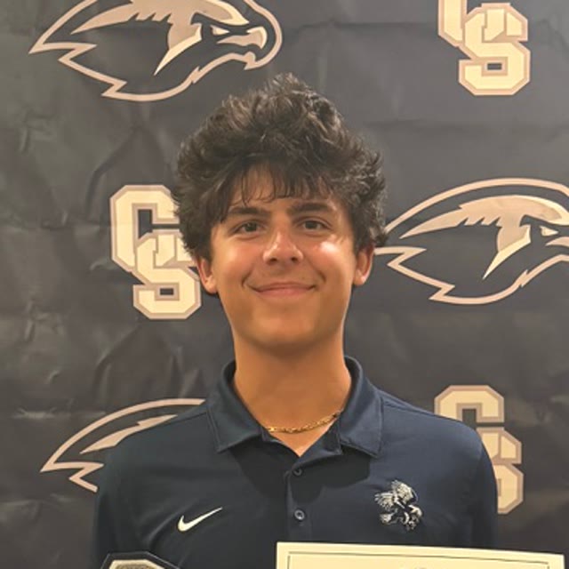 Matthew Bauer portrait in front of the Cactus Shadows Falcons backdrop
